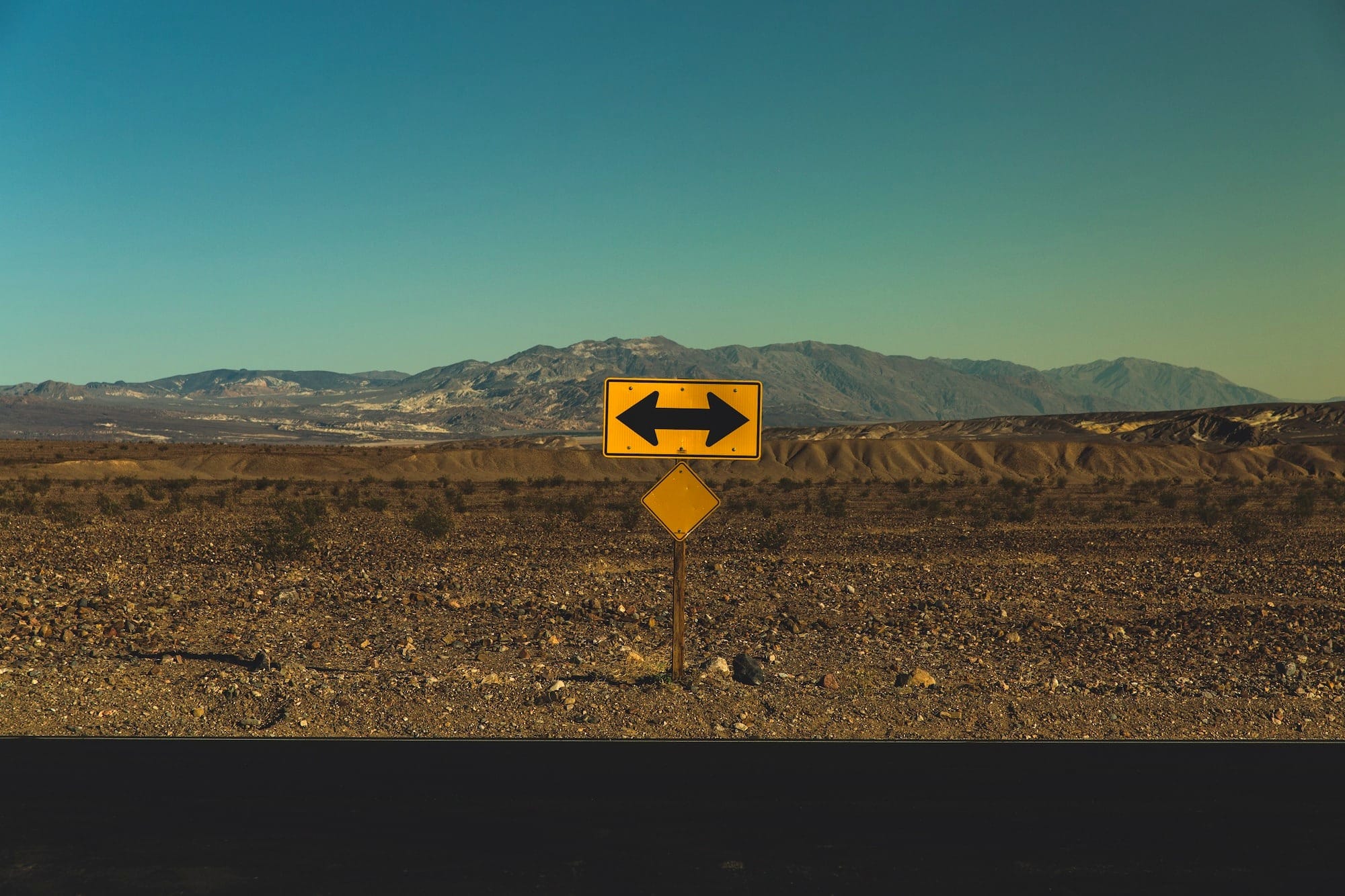 yellow arrow road sign